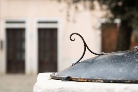 Lid of an old well in Venice (Italy) made of iron