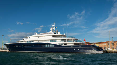 Big yacht tied up in the lagoon of Venice (Italy) on a sunny day in winter