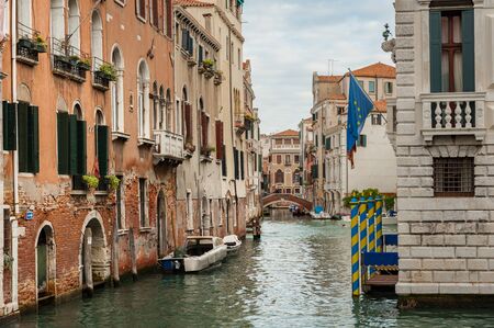 Canal with boats in Venice (Italy) on a cloudy day in late autumnの写真素材