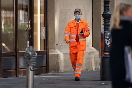 Vienna, Austria - April 04, 2020: Man wearing a mask on the street, protection against corona virus infection, sunny day in springtimeのeditorial素材