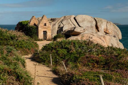 Ruin of an old stone house in Ploumanach (Brittany, France) on a sunny day in summerの写真素材