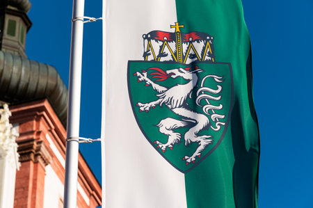 Closeup of the flag of Styria in front of church in Mariazell (Austria), sunny day in springtime
