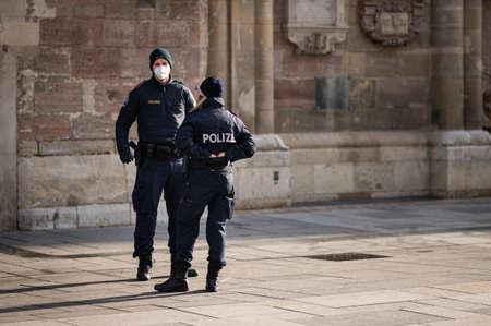 Vienna, Austria - February 02, 2021: Two Austrian policemen standing in front of churchのeditorial素材