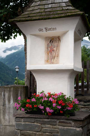 Wayside shrine with flowers in Virgen (East Tyrol, Austria) on a cloudy day in summerの写真素材