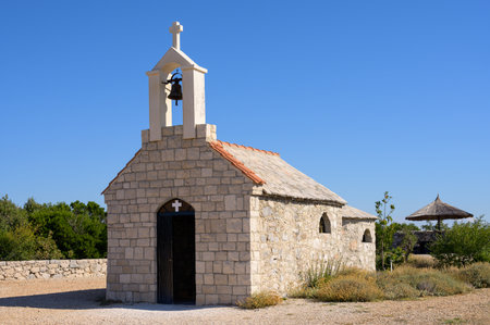 Small chapel on a hill near Lake Vrana, Dalamatia (Croatia), sunny day in late summer, blue skyの写真素材