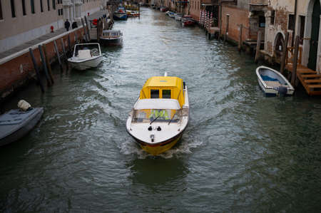 Venice, Italy - October 25, 2021: Yellow ambulance boat in the lagoon of Venice, canal, cloudy day in autumnのeditorial素材