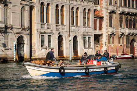 Venice, Italy - October 28, 2021: Transportation boat on the Canale Grande in Venice, sunny day in winterのeditorial素材