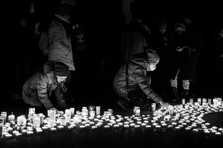 Vienna, Austria - February 27, 2022: People demonstrating against war in Ukraine on Heldenplatz, night, burning candles on the groundのeditorial素材