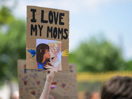 Vienna, Austria - June 11, 2022: People at Vienna Pride on Wiener Ringstrasse, sign I love my moms