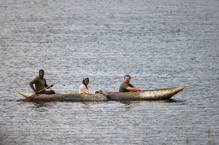 Kabale, Uganda - June 12, 2022: Tourist in a dugout canoe on Lake Bunyonyi (Uganda), sunny day in summerのeditorial素材