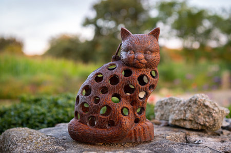 A little cat statue made out of metal, sunlight, natureの写真素材