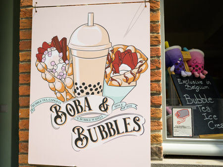 Bruges, Belgium - July 4, 2022: An advertising poster in front of a bubble tea shop, daylight, summerのeditorial素材
