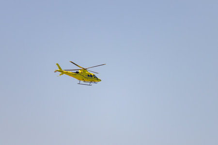 Cap de gris nez, France - July 7, 2022: A helicopter flying in the sky at daylight, machine, clouds