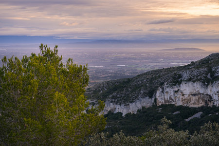 Sunrise in the Alpilles (Provence, France) on a partly cloudy day in springtimeの写真素材