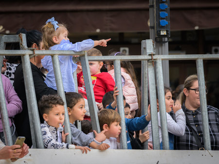 Arles, France - March 11, 2023: Girls watching bull fight at Capea du Forum, a traditional free event organised by the Taurine d'Arles Schoolのeditorial素材