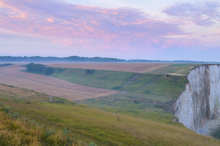 Coast and high cliffs near Ault at sunrise in summer, colorful sky, northern Franceの写真素材