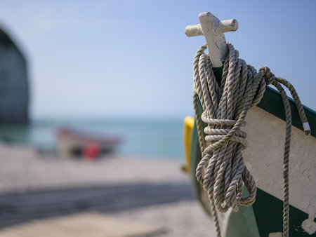 Yport, France - July 21, 2022: The front of a small green white fishing boat lying on the beach of Yport, sunny day in summer, ropeのeditorial素材