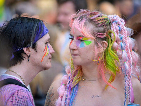 Vienna, Austria - June 17, 2023: People at Vienna Pride in summer on Wiener Ringstrasse, woman with painted face and colorful hairのeditorial素材