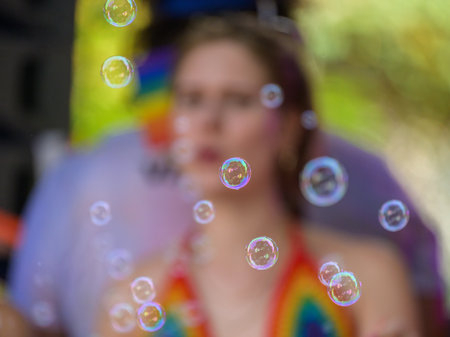 Vienna, Austria - June 17, 2023: People at Vienna Pride in summer on Wiener Ringstrasse, soap bubblesのeditorial素材