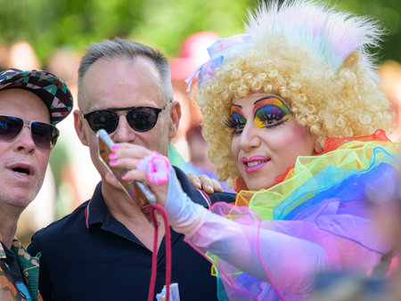 Vienna, Austria - June 17, 2023: People at Vienna Pride in summer on Wiener Ringstrasse, drag queen taking photo with smartphoneのeditorial素材