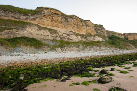 Cliffs on Omaha beach near Vierville-sur-Mer (Normandy, France) on a summer morningの写真素材
