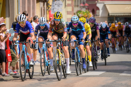 Muster, France - July 30, 2022: Athletes and escorts of the Tour de France Femmes passing through the city, group of athletesのeditorial素材