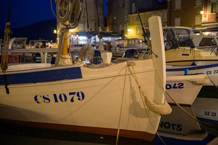 Cres, Croatia - October 24, 2022: Boats in the harbor of Cres (Croatia) after sunsetのeditorial素材