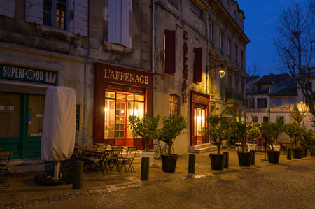 Arles, France - March 7, 2023: Empty street in the center of Arles (France) in the night, shopsのeditorial素材