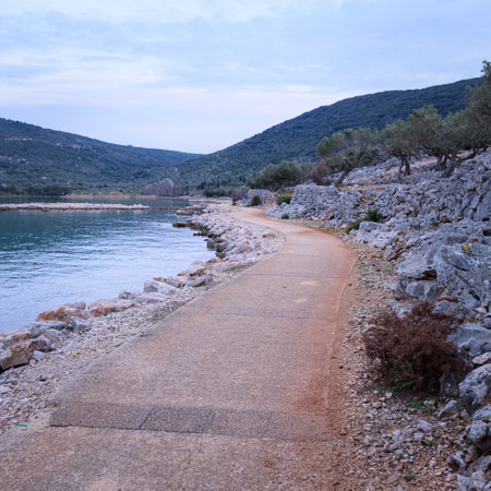 Path and calm sea near Cres (Croatia) after sunset in springtimeの写真素材