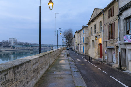 Arles, France - March 07, 2023: Street along river Rhone in Arles on a cloudy evening in winterのeditorial素材