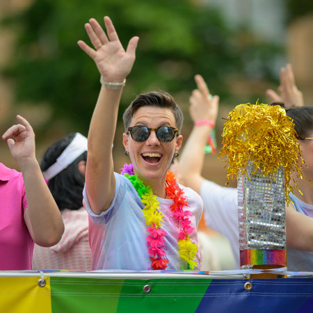 Vienna, Austria - June 08, 2024: People at Vienna Pride in summer on Wiener Ringstrasse, woman...