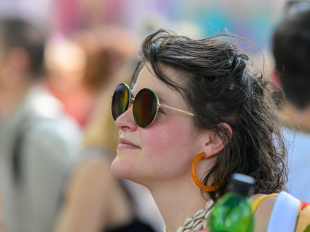Vienna, Austria - June 08, 2024: People at Vienna Pride in summer on Wiener Ringstrasse, portrait of a woman with sunglassesのeditorial素材