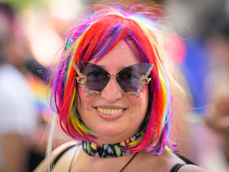 Vienna, Austria - June 08, 2024: People at Vienna Pride in summer on Wiener Ringstrasse, portrait of a woman with sunglasses and colorful hairのeditorial素材
