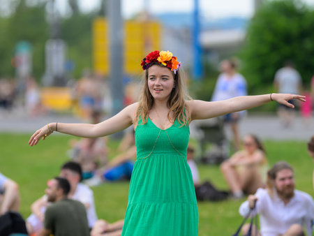 Vienna, Austria - June 08, 2024: People at Vienna Pride in summer on Wiener Ringstrasse, woman in green dress dancingのeditorial素材