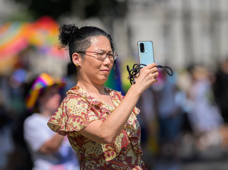 Vienna, Austria - June 08, 2024: People at Vienna Pride in summer on Wiener Ringstrasse, woman...