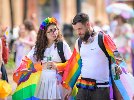 Vienna, Austria - June 08, 2024: People at Vienna Pride in summer on Wiener Ringstrasse, couple walking on the streetのeditorial素材