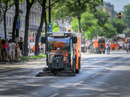 Vienna, Austria - June 08, 2024: People at Vienna Pride in summer on Wiener Ringstrasse, cleaning vehicle cleaning the street after the paradeのeditorial素材