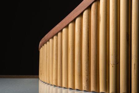 Closeup of a pan flute on a table, black backgroundの写真素材