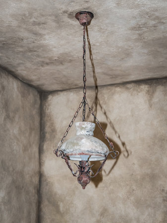 Niedersulz, Austria - May 27, 2018: A vintage lamp hangs from the ceiling displayed indoors at a museum showing historic household lighting.のeditorial素材