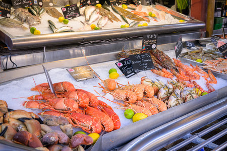Trouville-sur-Mer, France - July 26, 2022: A seafood counter is filled with many different marine products in a local fish market.のeditorial素材