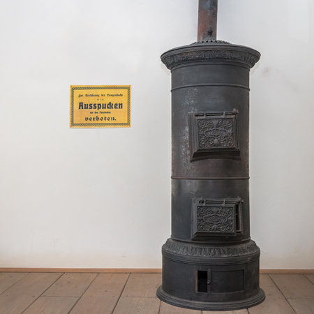 Niedersulz, Austria - May 27, 2018: An old wooden stove is displayed indoors at a museum exhibition showing historic household technology.のeditorial素材