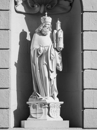 Saint Leopold white stone statue holding a church against yellow wall of Klosterneuburg Abbey black and whiteの写真素材