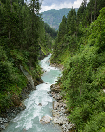 Isel gorge viewed from above in Virgen Austria cloudy summer season showing dramatic alpine landscape and natural environmentの写真素材