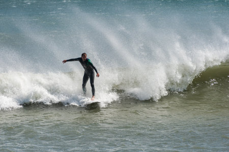 La Hague, France - August 20, 2016: Surfer performing on powerful ocean wave at French summer coast...