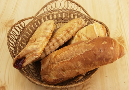 Long loaf of bread and home baking in basket
