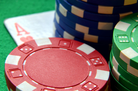 Blue, green and red poker chips pile and ace detail