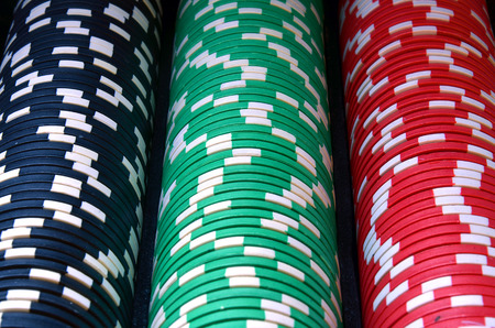 Red, blue, green, white and black poker chips columnsの写真素材