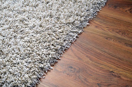 White shaggy carpet on brown wooden floor detailの写真素材