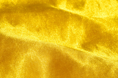 Close-up detail of gold satin fabric patternの写真素材