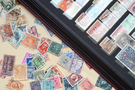 Album with old postage stamps close-up detailの写真素材
